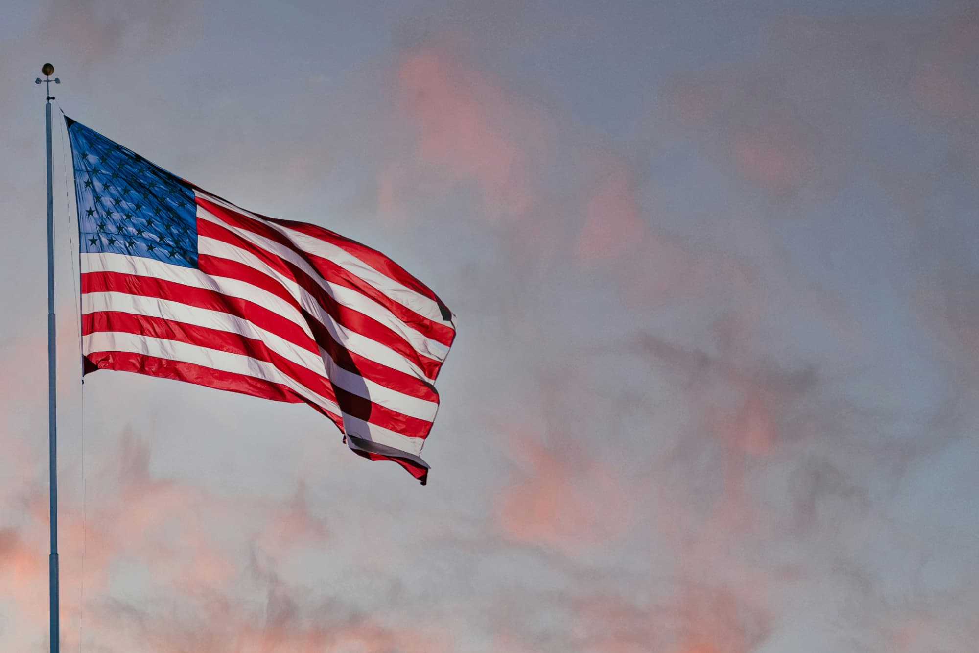 American flag against a sunset sky